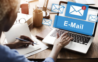 A woman using a laptop to check her email
