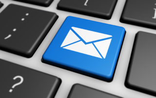 A keyboard with a button depicting an envelope, representing email